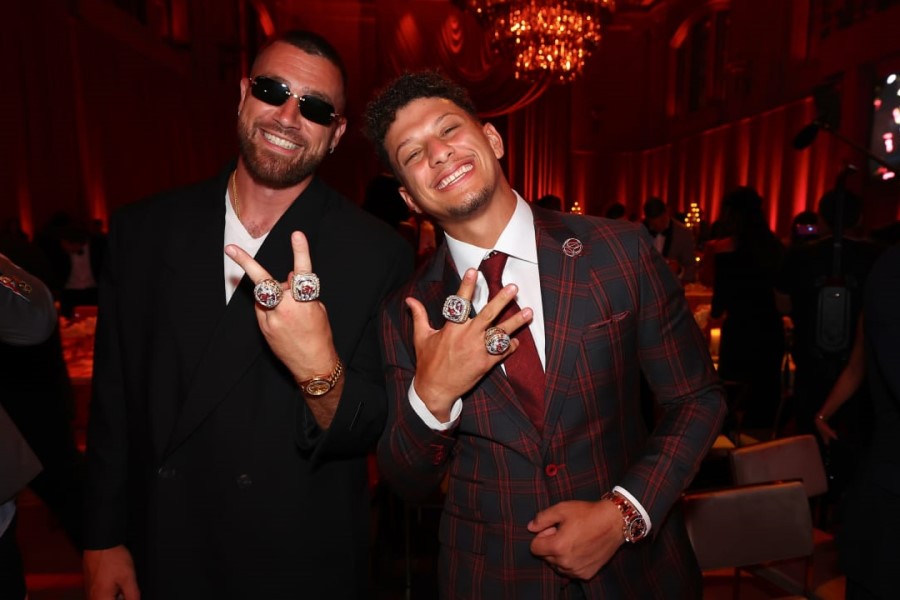 Two Kansas City Chiefs players showing off their Super Bowl 57 rings